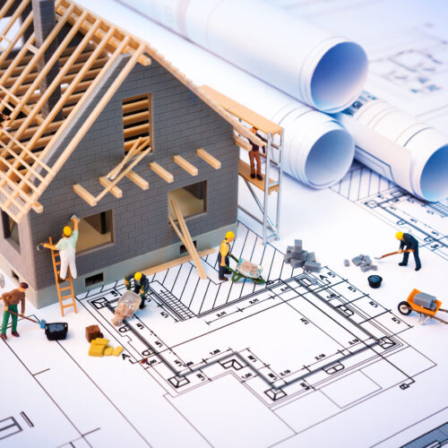 Building,House,On,Blueprints,With,Worker,-,Construction,Project Building,House,On,Blueprints,With,Worker,-,Construction,Project